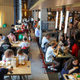 People sitting at tables and eating.